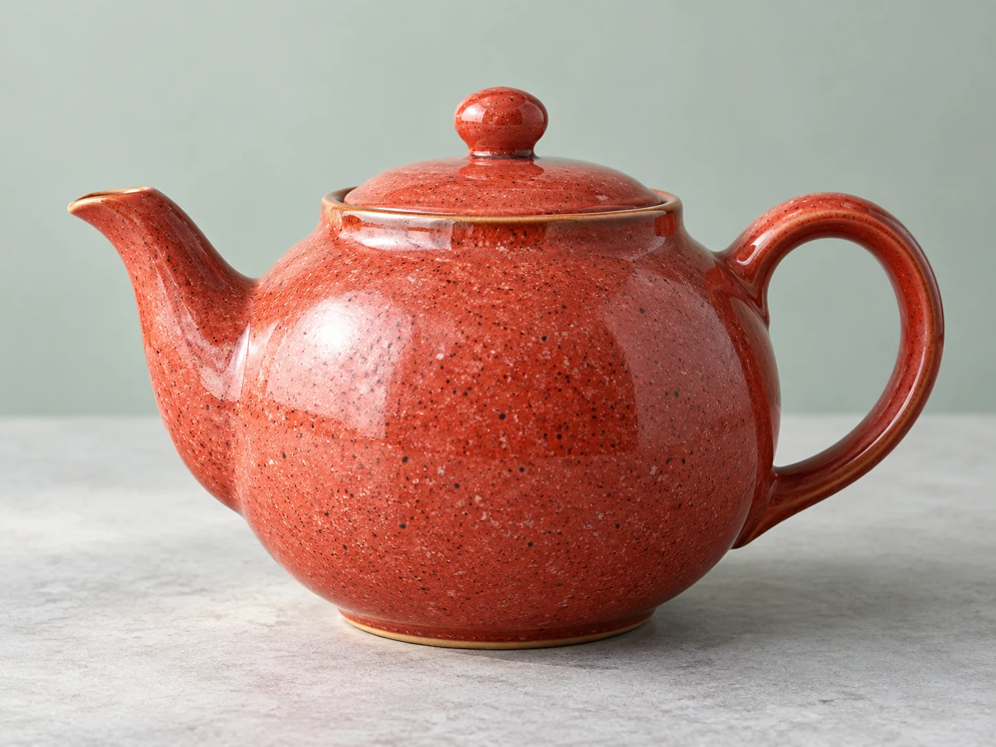 Coral ceramic teapot with a finely speckled glaze